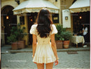 Woman in Yellow Dress Walking on City Street During Day