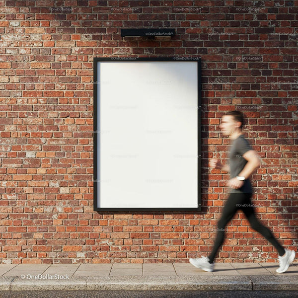 Urban runner passing blank poster on brick wall JPG Mockup Image