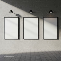 Three Blank Vertical Frames on Concrete Wall with Lamps
