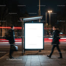 Illuminated urban bus stop sign glowing at night