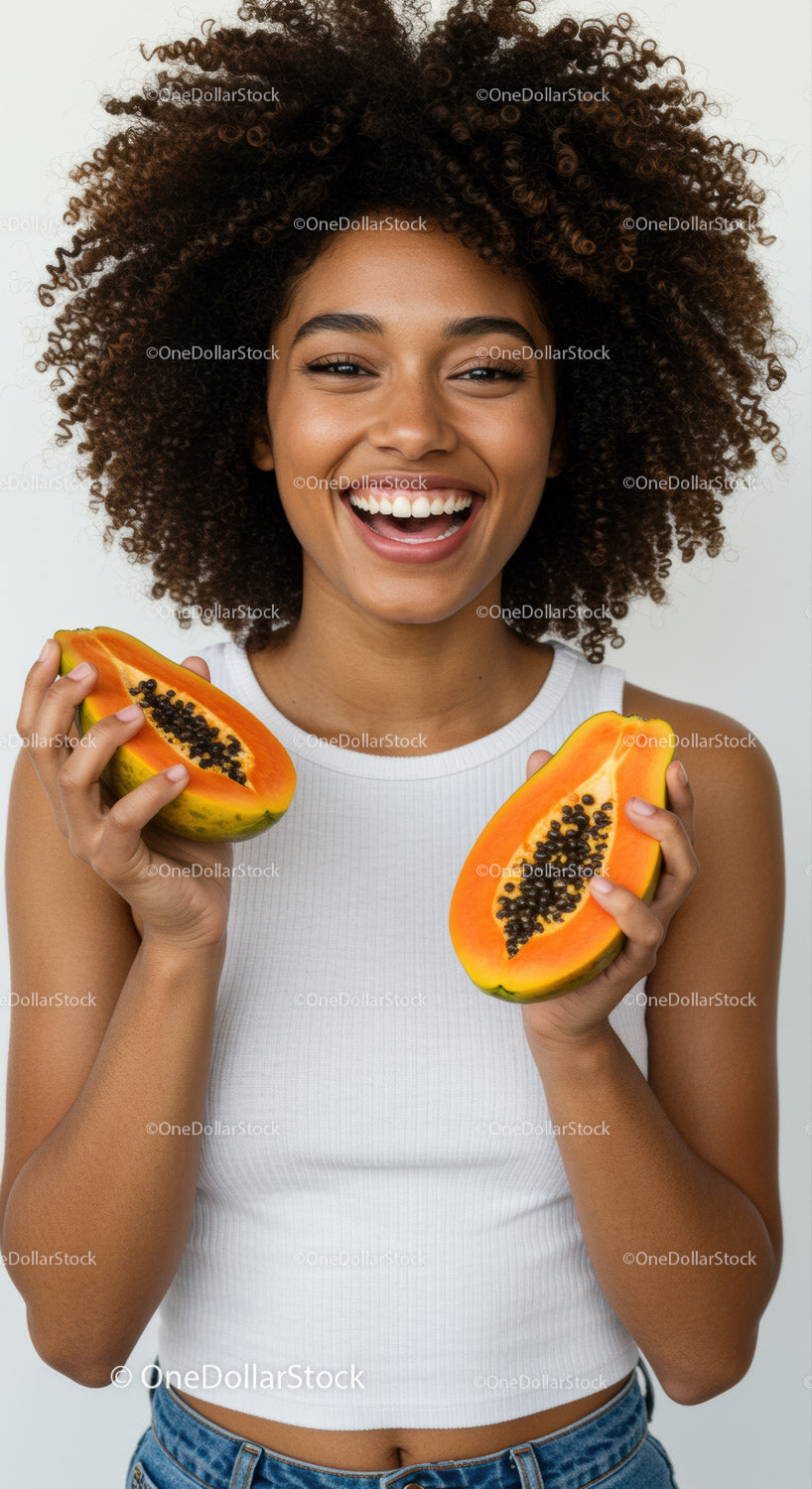 Joyful Woman Holding Halved Papaya in Front of White Background