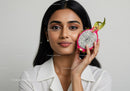 Portrait of a Woman with Vibrant Dragon Fruit in Bright Natural Setting