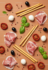 Italian antipasto ingredients layout with prosciutto and basil