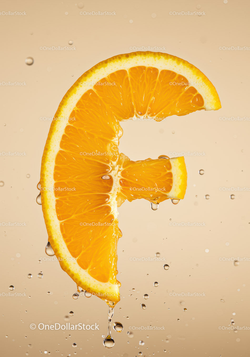 Fresh orange slice shaped like letter F with water drops