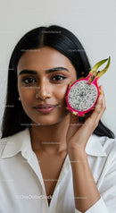 Young Woman with Bright Smile Holding Fresh Dragon Fruit for Healthy Lifestyle