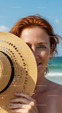 Woman with Straw Sunhat on Beach Under Bright Blue Sky