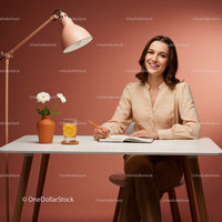 Cheerful Woman Writing at a Table with Flowers and Drinks