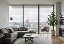 Modern Living Room with Floor-to-Ceiling Windows and Cityscape View