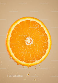 Fresh orange slice with water droplets on beige background