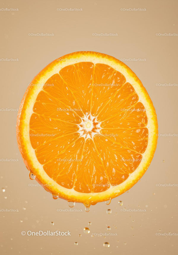 Fresh orange slice with water droplets on beige background