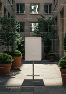 Blank presentation board in quiet urban courtyard