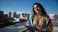 Happy Woman in Boho Style with Tablet on City Rooftop