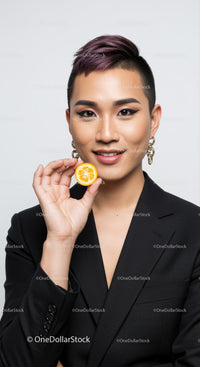 Portrait of a Confident Young Woman with Short Purple Hair Holding Lemon Slice