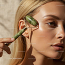 Elegant Woman Using Jade Facial Roller for Skin Rejuvenation
