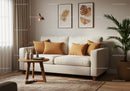 Cozy beige sofa with warm earth tone cushions