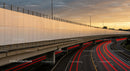 Urban Highway at Sunset with Red Light Trails and Overpass
