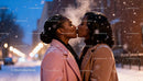 Couple Sharing a Romantic Kiss in Snowy Evening
