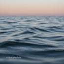 Serene Ocean Waves at Sunset with Pink Sky