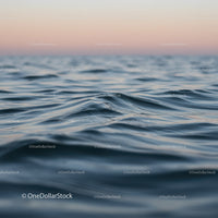 Serene Ocean Waves at Sunset with Pink Sky