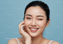Cheerful Young Woman Smiling Playfully on Blue Background