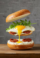 Delicious sandwich with runny egg and sun-dried tomatoes