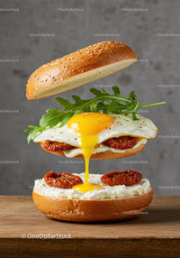 Delicious sandwich with runny egg and sun-dried tomatoes