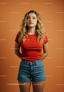 Blonde woman in red shirt looking thoughtfully upward