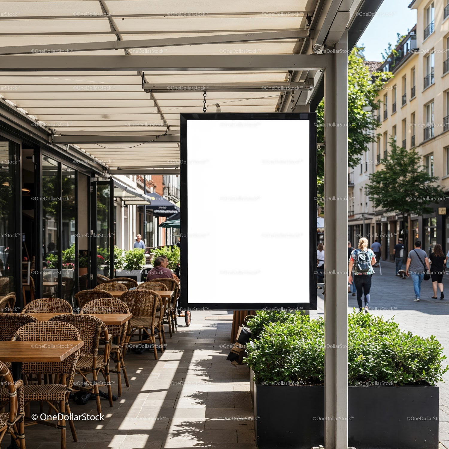 Empty outdoor cafe seating with blank street sign