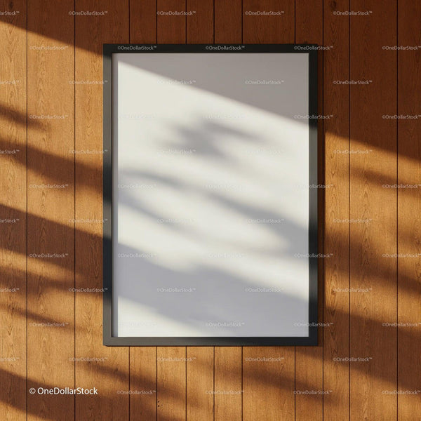 Blank black frame on wooden wall with soft shadows JPG Mockup Image