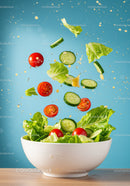Fresh vegetable salad tossing in white bowl