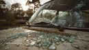 Abandoned Vintage Car with Broken Glass at Sunset