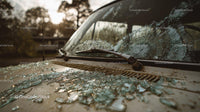 Abandoned Vintage Car with Broken Glass at Sunset