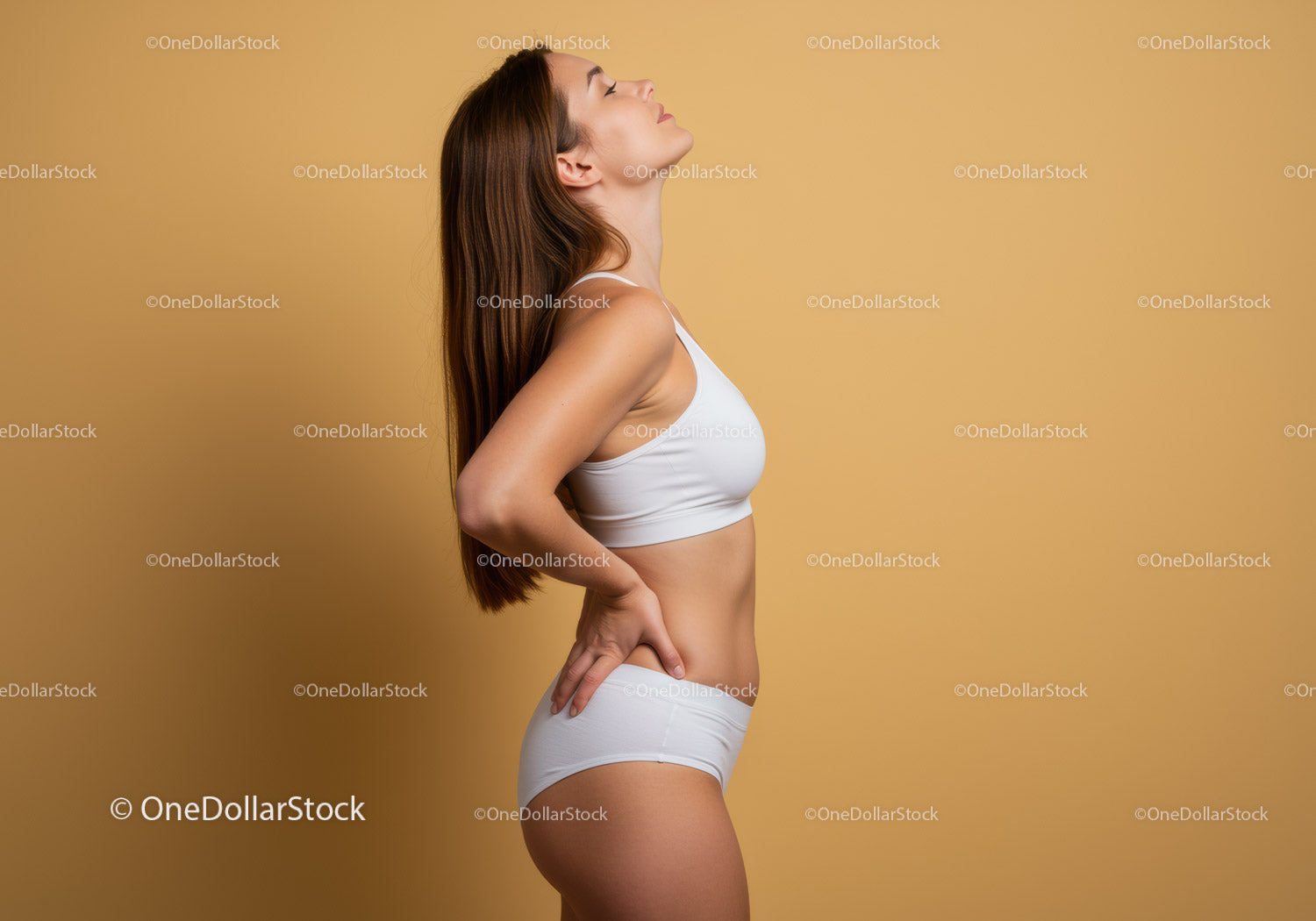 Confident Young Woman in White Sportswear Posing Against Beige Background