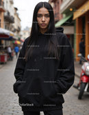 Fashionable Woman Wearing Black Hoodie in Urban City Street