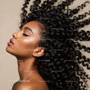 Profile of woman with voluminous curly hair and smooth skin