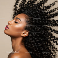 Profile of woman with voluminous curly hair and smooth skin
