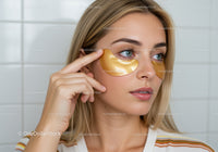 Young Woman Applying Gold Under-Eye Patches for Skincare Routine