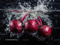 Vibrant Red Radishes Splashing into Water