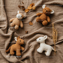 Soft Plush Animal Toys on Cozy Brown Fabric Background