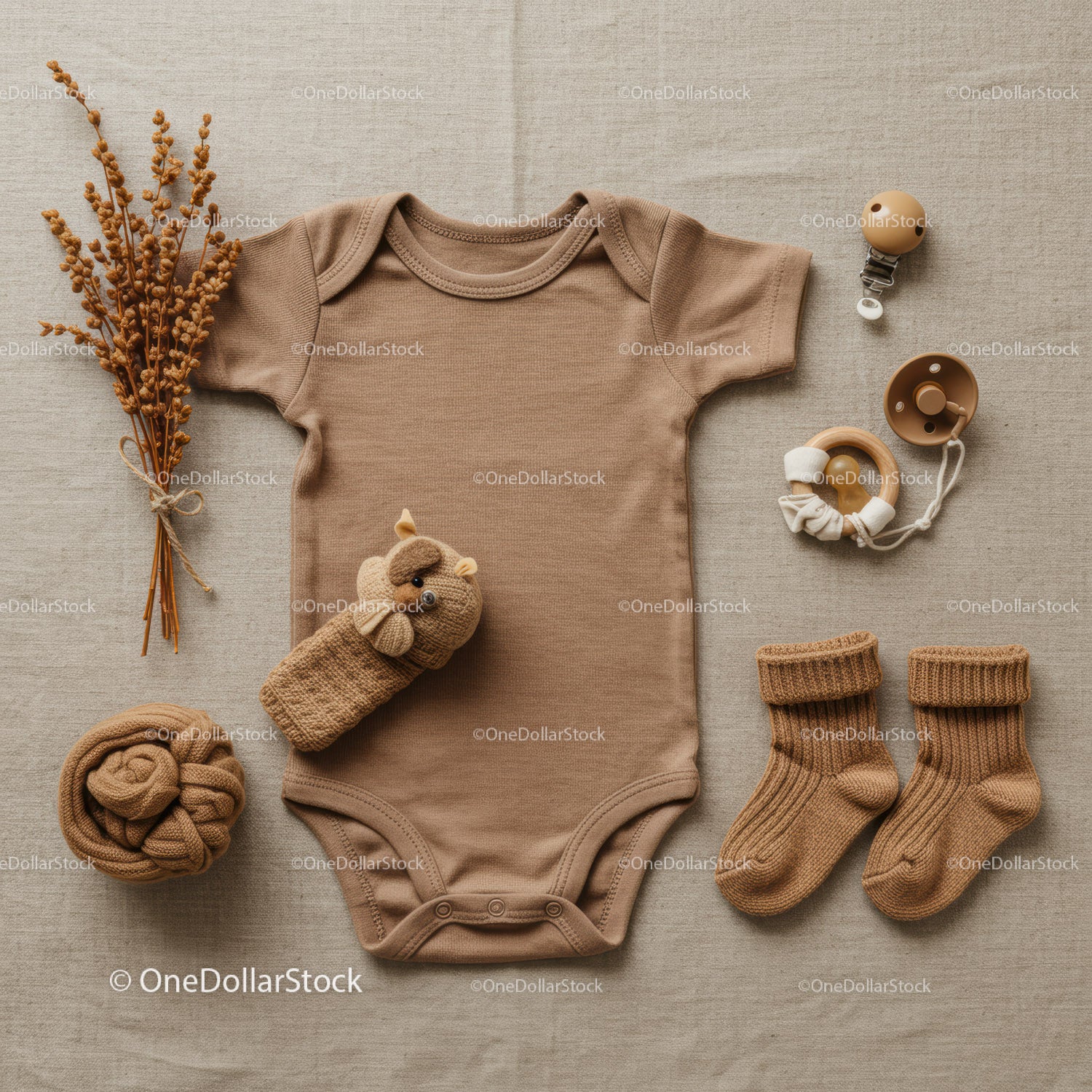 Neutral toned baby clothing set with soft accessories