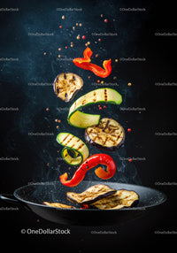 Grilled vegetables tossing in a sizzling pan with spices