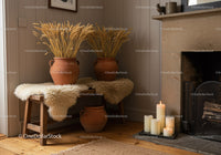 Cozy rustic corner with wheat decor and lit candles