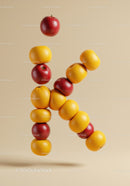 Floating letter K composed of fresh fruit