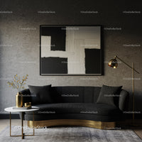 Modern living room with black sofa and abstract art