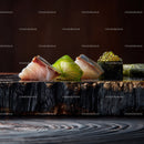 Gourmet Sushi Assortment with Fresh Fish and Seaweed on Black Plate