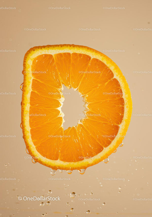 Fresh orange slice floating with water droplets
