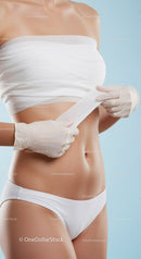 Female Doctor Applying Elastic Bandage to Abdomen for Medical Care