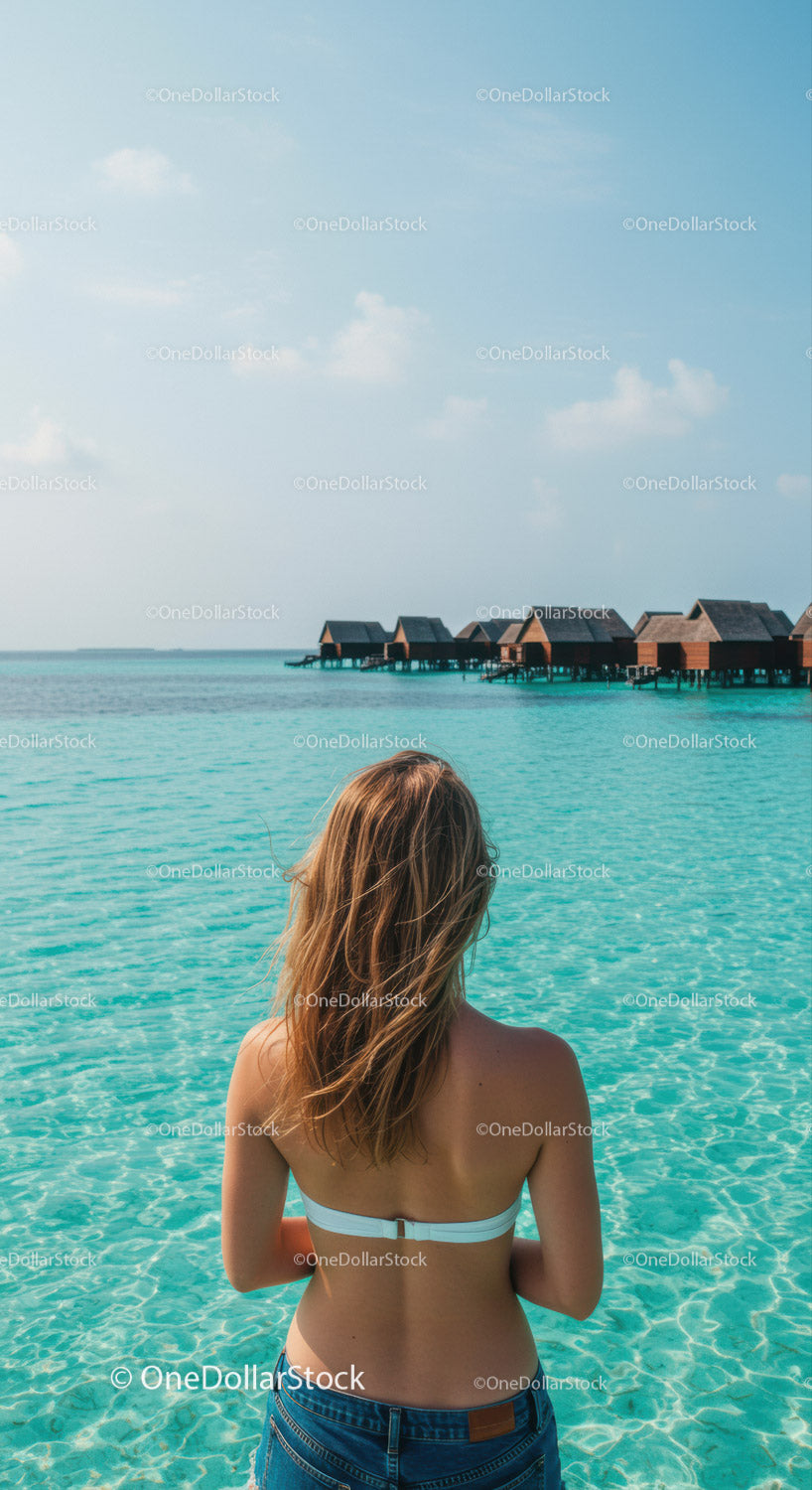 Woman Watching Over Water Villas on Tropical Ocean Vacation Scene