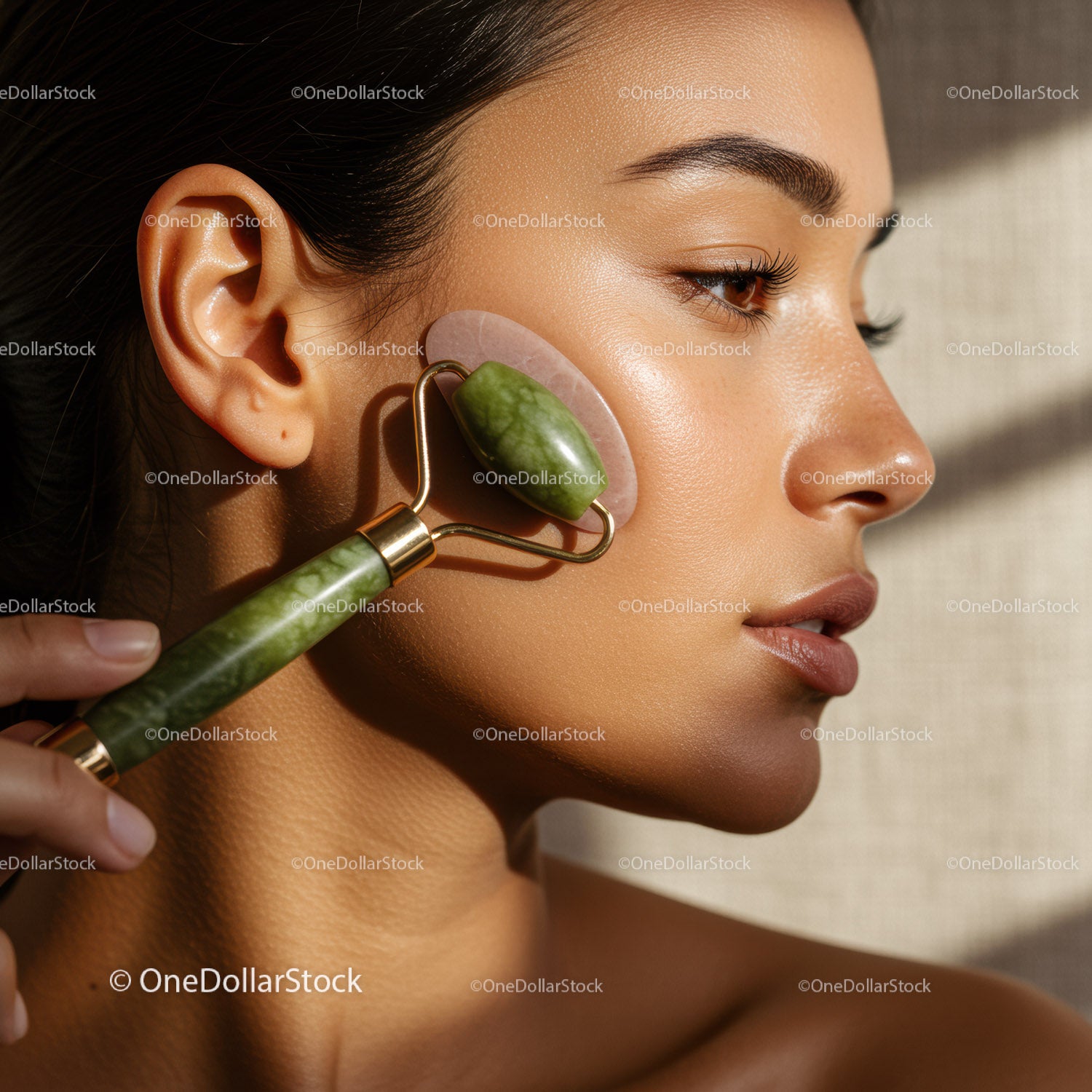 Close-up of a woman receiving facial massage with jade roller