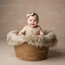 Adorable baby smiling in cozy basket with fur lining